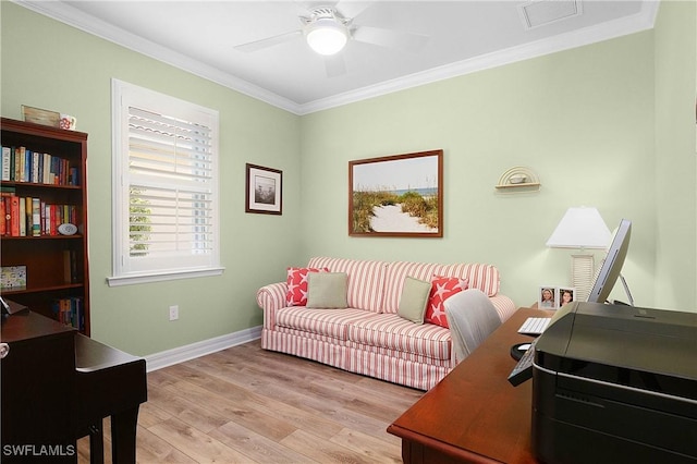 home office with crown molding, ceiling fan, and light wood-type flooring