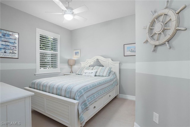 bedroom featuring light carpet and ceiling fan