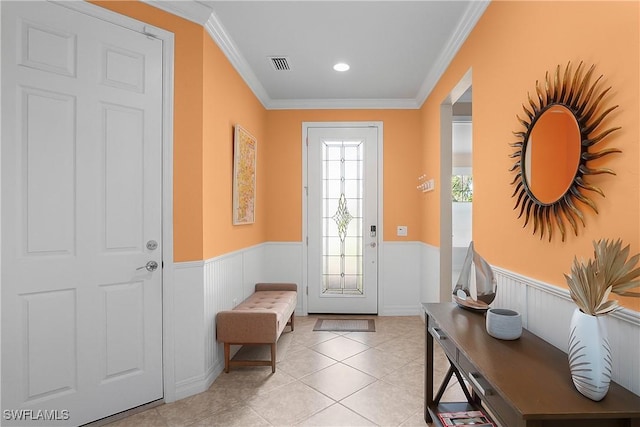 entryway featuring light tile patterned floors and crown molding