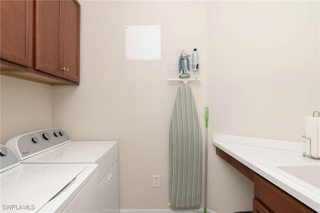 laundry area with cabinets and washer and clothes dryer