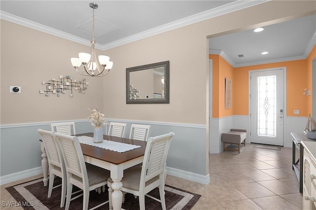 dining space featuring ornamental molding, light tile patterned floors, and a chandelier