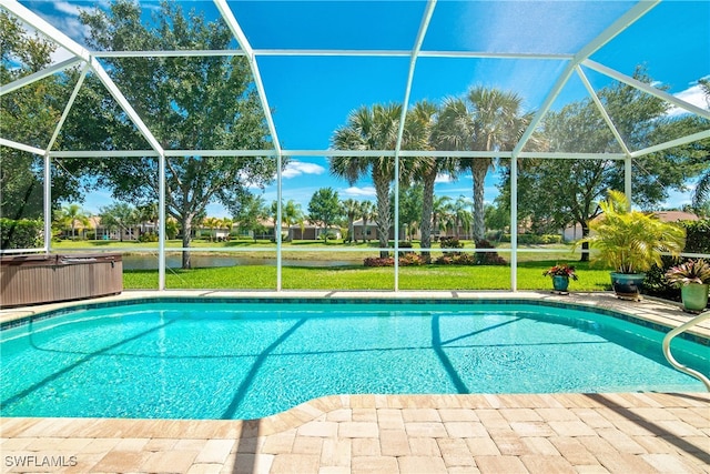 view of swimming pool featuring glass enclosure, a patio, and a hot tub