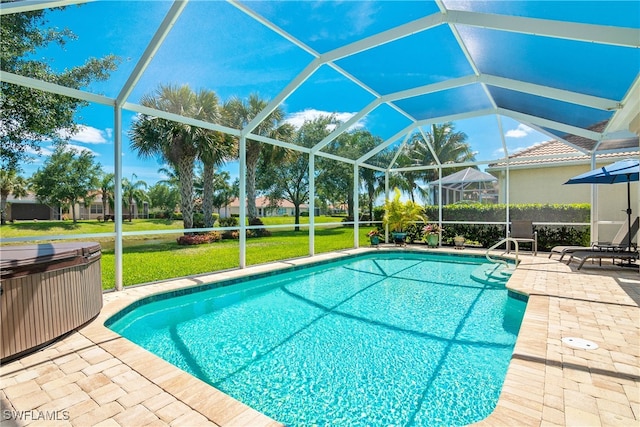 view of swimming pool with glass enclosure, a patio area, and a yard