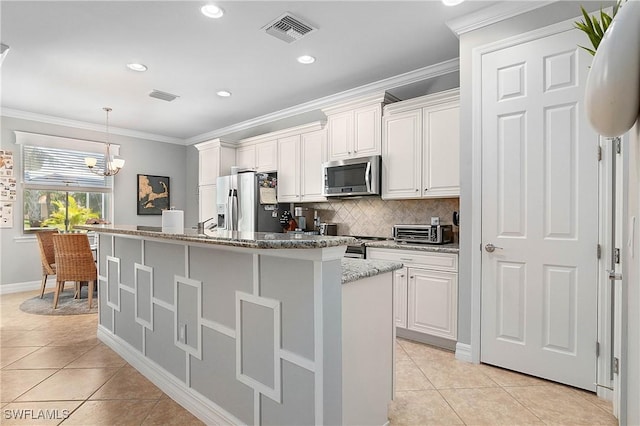 kitchen with white cabinetry, an island with sink, and appliances with stainless steel finishes