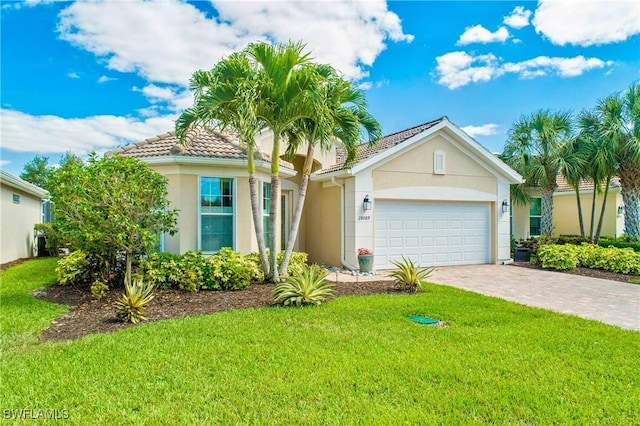 view of front of home featuring a garage and a front lawn