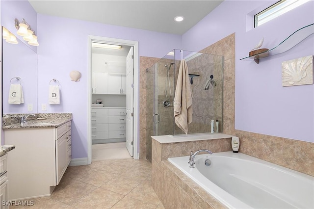 bathroom with vanity, tile patterned flooring, and plus walk in shower