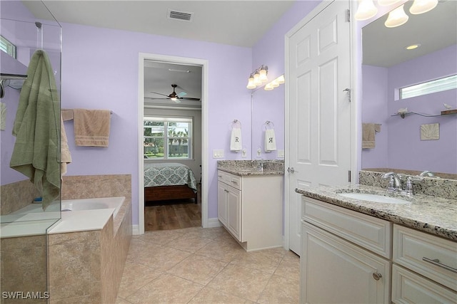 bathroom featuring vanity, tiled bath, tile patterned floors, and ceiling fan