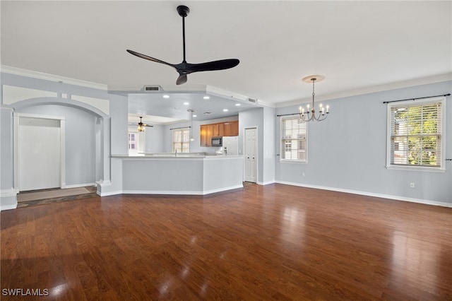 unfurnished living room with crown molding, ceiling fan with notable chandelier, and dark hardwood / wood-style floors