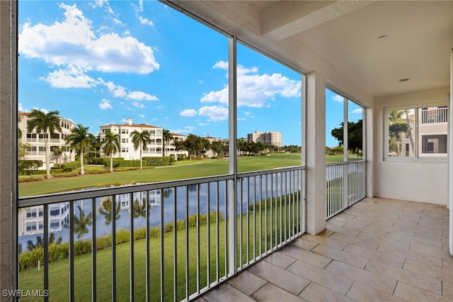 unfurnished sunroom featuring a water view