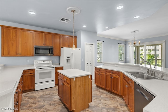 kitchen featuring a center island, sink, a notable chandelier, hanging light fixtures, and stainless steel appliances