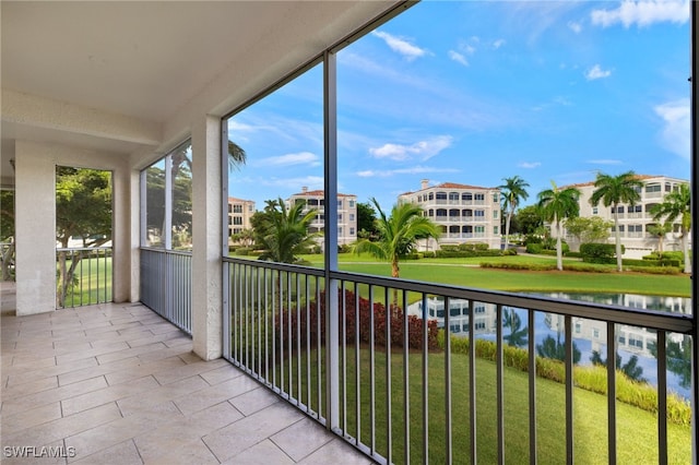 unfurnished sunroom featuring a water view