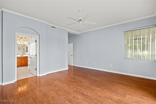 empty room with ceiling fan, light hardwood / wood-style flooring, and ornamental molding