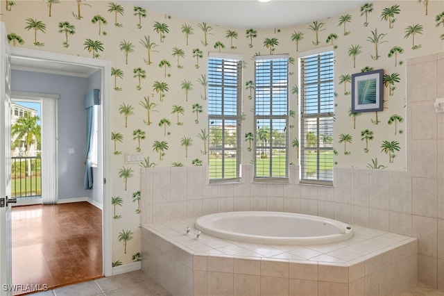 bathroom with tiled tub and hardwood / wood-style flooring