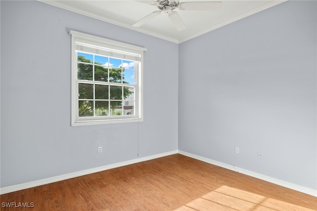 empty room featuring crown molding, hardwood / wood-style floors, and ceiling fan