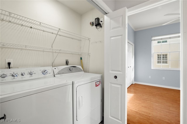 washroom with hardwood / wood-style flooring and washer and clothes dryer