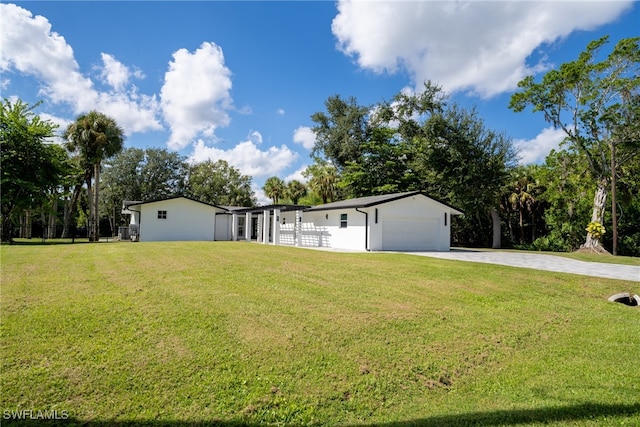 view of front of house with a garage and a front lawn