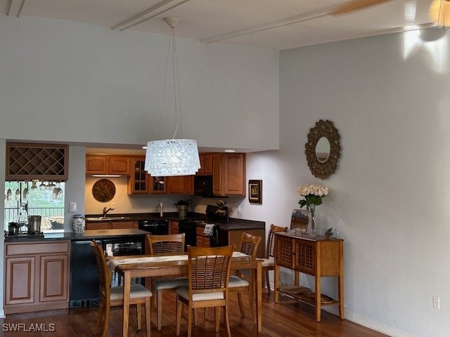 kitchen with sink, dark hardwood / wood-style flooring, and black appliances