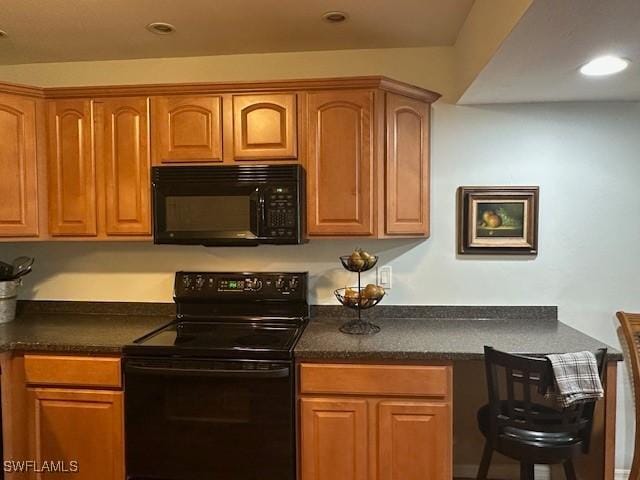 16679 Forest Blvd Unit 203, Fort Myers, FL 33908 - kitchen featuring brown cabinets, black appliances, and dark countertops