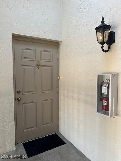 16679 Forest Blvd Unit 203, Fort Myers, FL 33908 - property entrance with stucco siding
