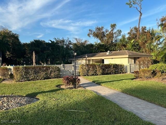 16679 Forest Blvd Unit 203, Fort Myers, FL 33908 - view of community with a lawn, a gate, and fence private yard
