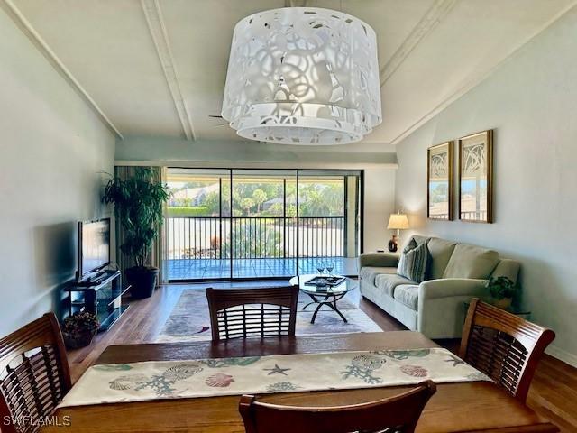 16679 Forest Blvd Unit 203, Fort Myers, FL 33908 - living area with wood finished floors and lofted ceiling