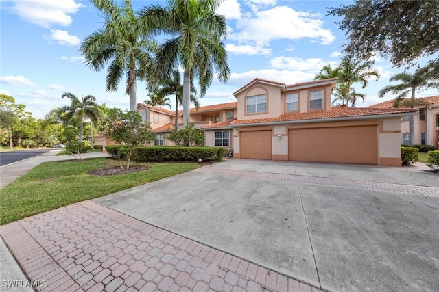 mediterranean / spanish-style home with a front lawn and a garage