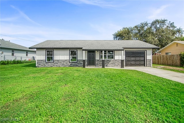 ranch-style home with a garage and a front lawn