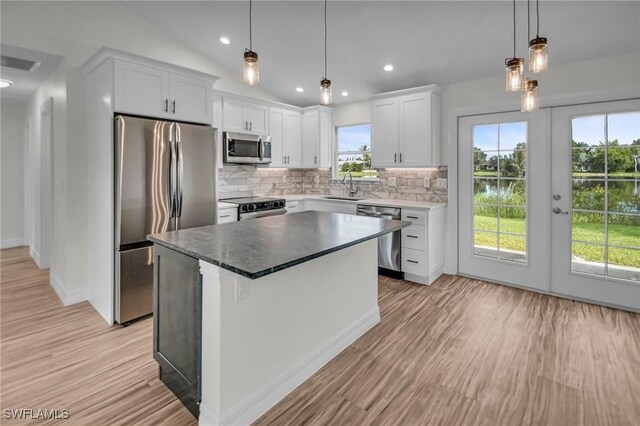 kitchen featuring sink, white cabinetry, a center island, and stainless steel appliances