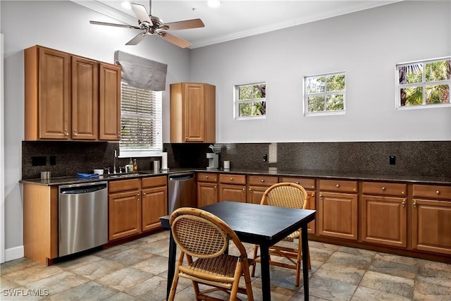 kitchen featuring a healthy amount of sunlight, ornamental molding, dishwasher, and sink