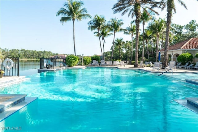 view of swimming pool with a water view