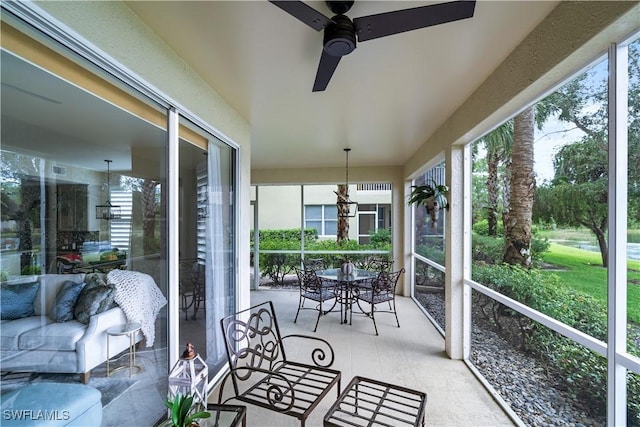 sunroom / solarium featuring ceiling fan