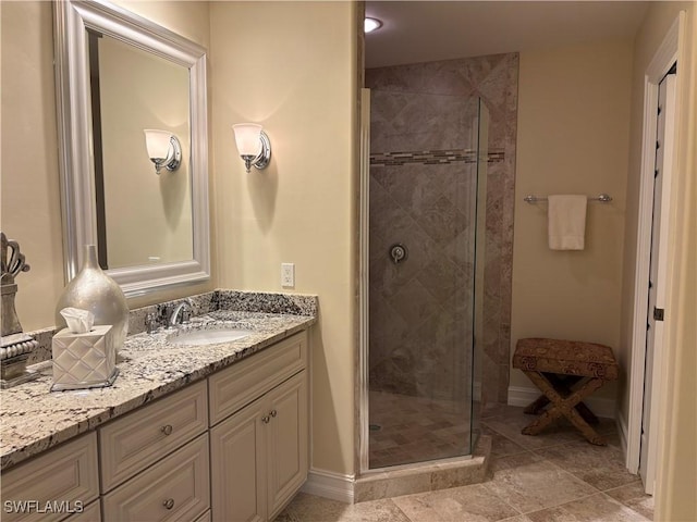 bathroom featuring walk in shower and vanity