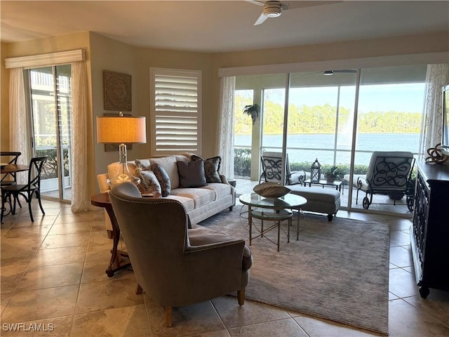 living room with ceiling fan, a healthy amount of sunlight, and tile patterned flooring