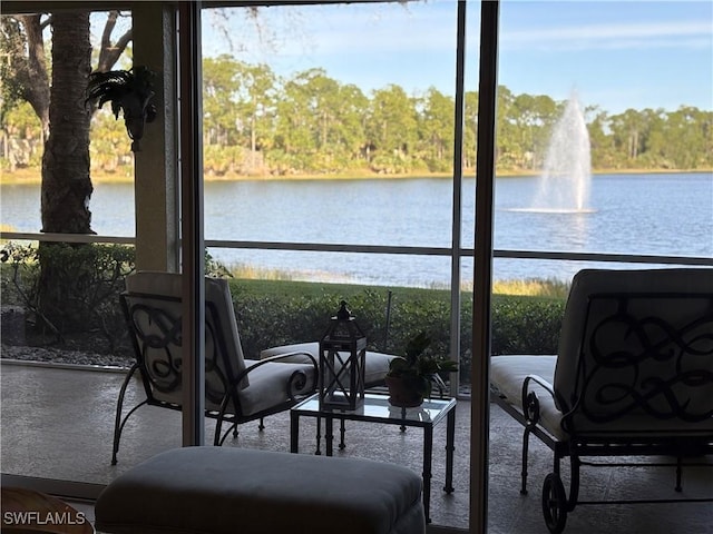 sunroom / solarium with a water view