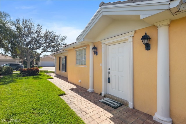 doorway to property with a lawn