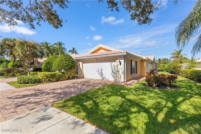 view of front of home with a front lawn and a garage