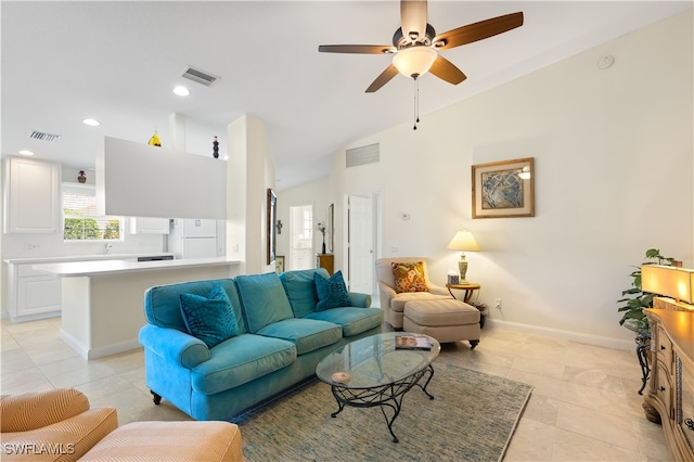 living room with ceiling fan, lofted ceiling, and light tile patterned floors