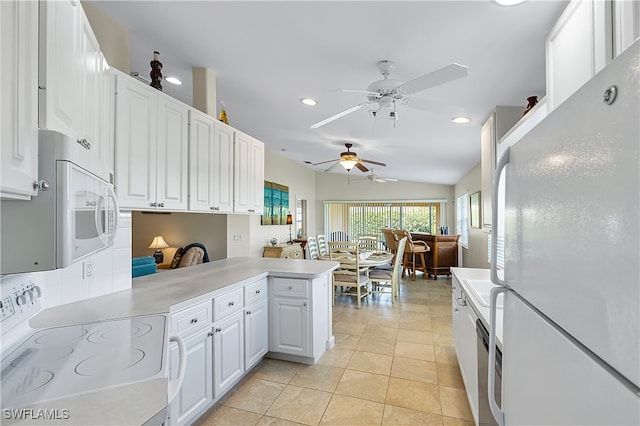 kitchen featuring white cabinetry, kitchen peninsula, lofted ceiling, white appliances, and light tile patterned floors