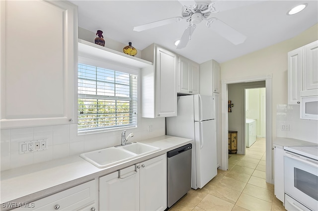 kitchen with sink, ceiling fan, light tile patterned floors, appliances with stainless steel finishes, and white cabinetry