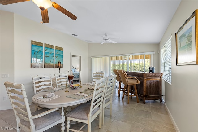 dining space with lofted ceiling and indoor bar