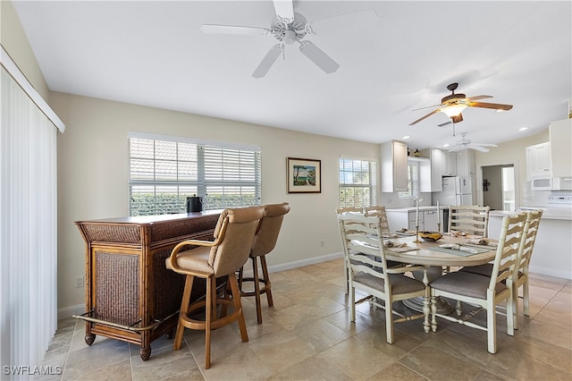 dining room featuring ceiling fan and a healthy amount of sunlight