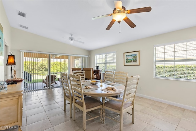 tiled dining area with ceiling fan and lofted ceiling