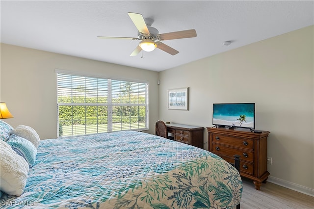 bedroom with ceiling fan and light wood-type flooring