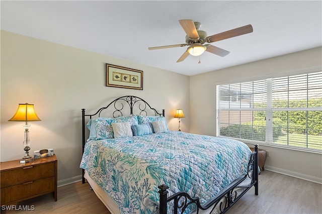 bedroom featuring wood-type flooring and ceiling fan