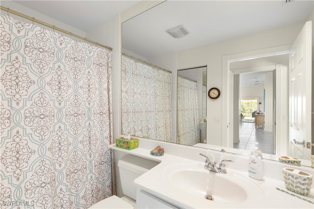 bathroom featuring tile patterned floors, vanity, and toilet