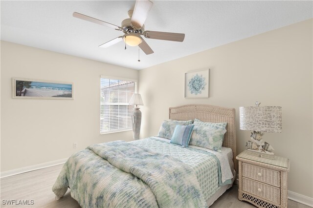 bedroom with ceiling fan and light hardwood / wood-style flooring