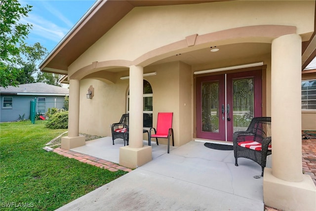 view of exterior entry with a lawn