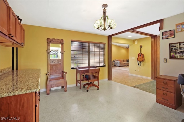 kitchen featuring hanging light fixtures, an inviting chandelier, and light stone countertops