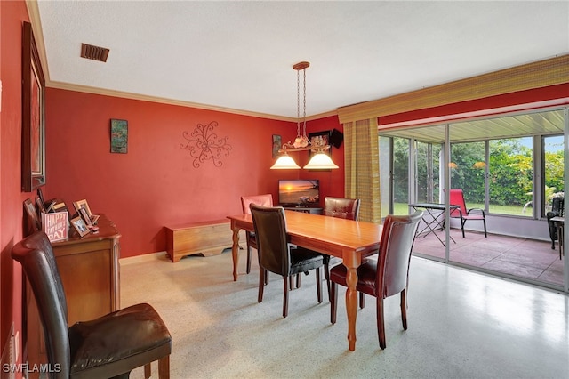 dining area featuring a chandelier, a textured ceiling, and crown molding