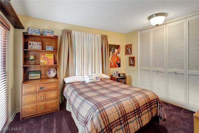 bedroom with dark colored carpet, a closet, and a textured ceiling